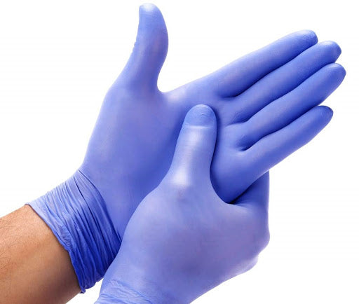 A person wearing nitrile medical examination gloves